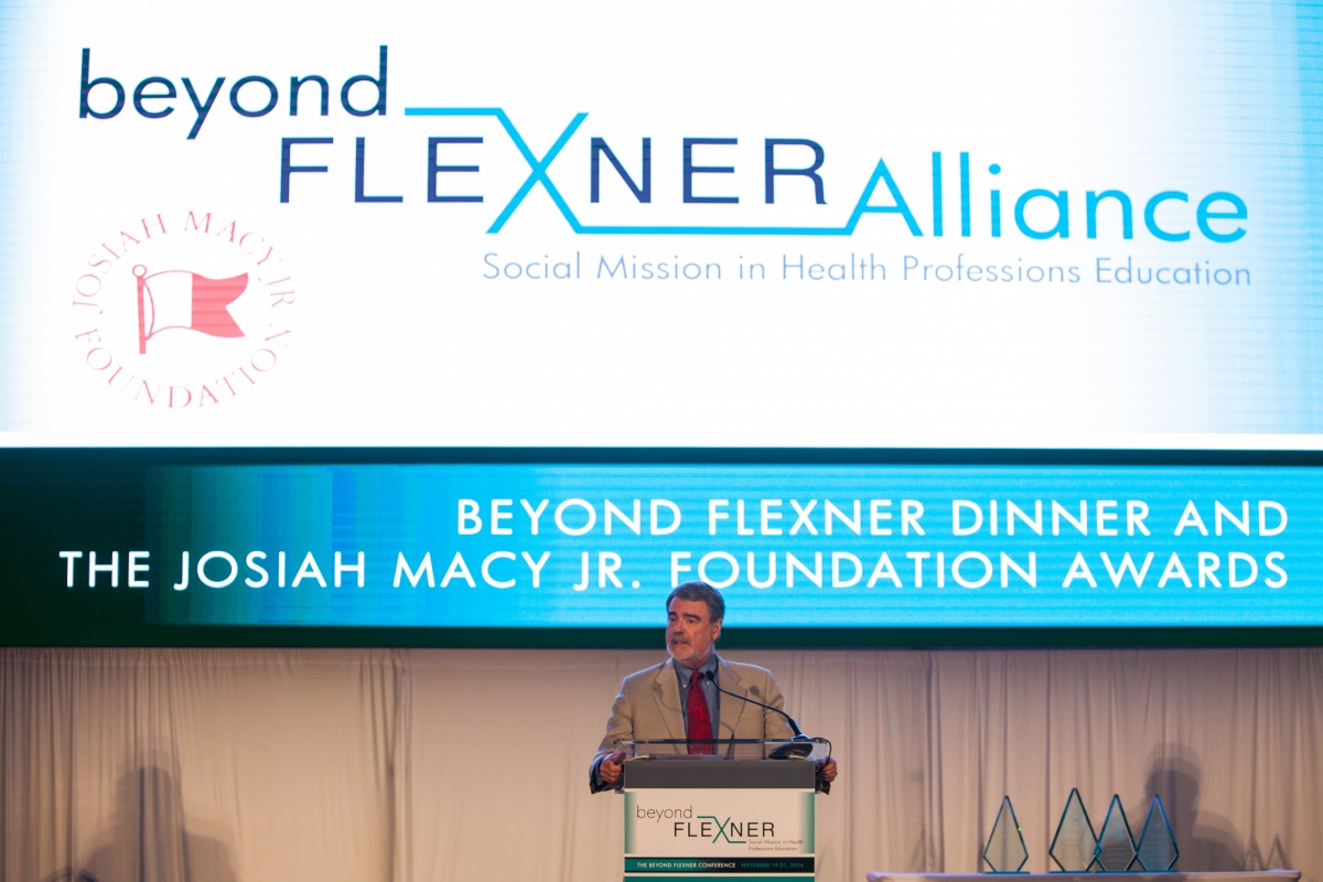 Fitzhugh Mullan Speaking at a podium at the 2016 BFA Conference