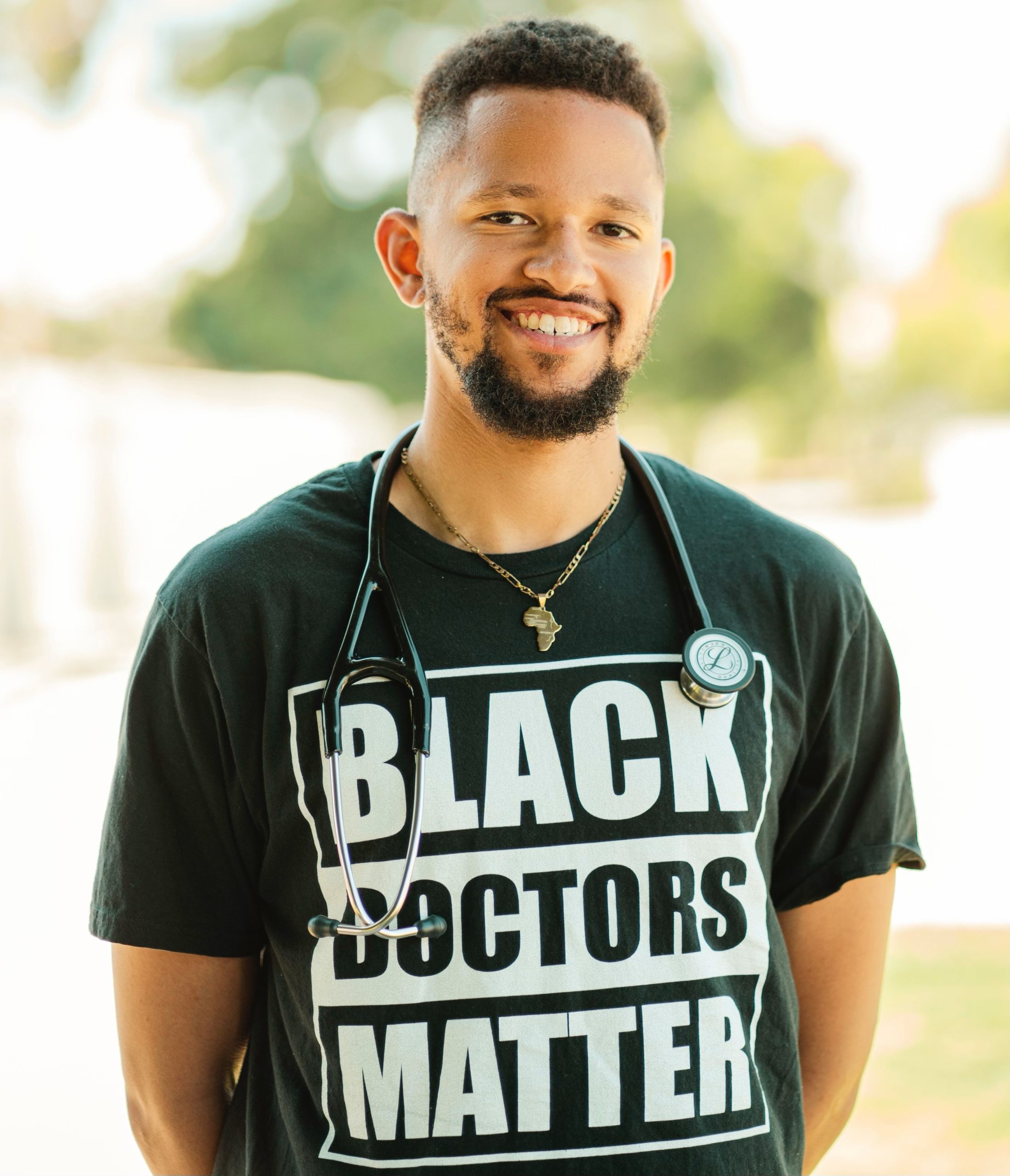 Makeen Yasar, wearing a shirt that says "Black Doctors Matter"