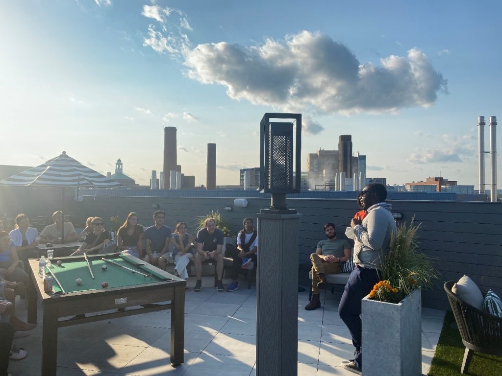 Health Justice course retreat, people gather at a rooftop restaurant and discuss outside