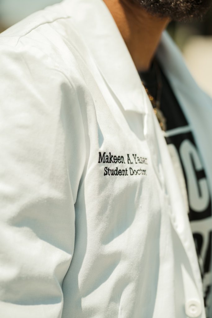 Doctor's white coat that reads "Makeen A. Yasar, Student Doctor"