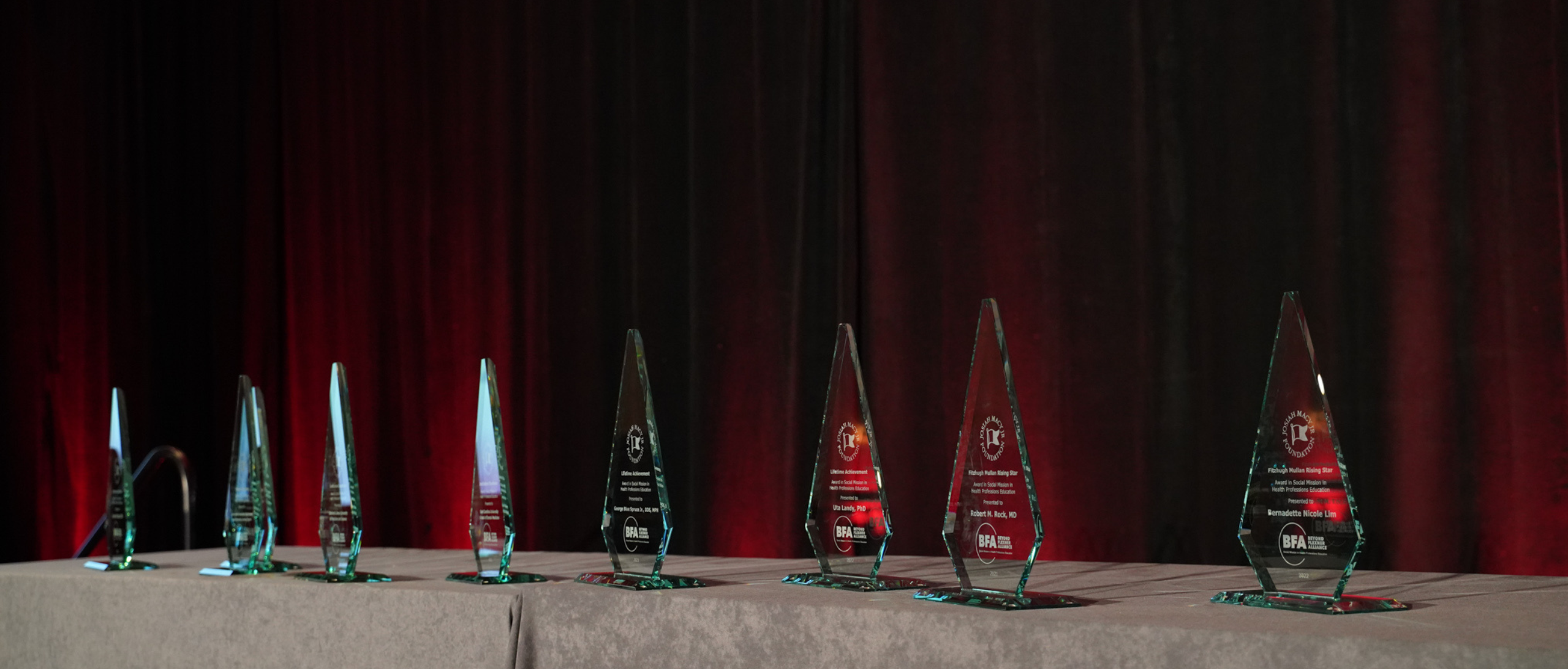 Glass Macy Awards trophies sit on a table
