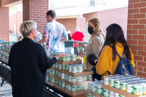Giving out canned food at a school